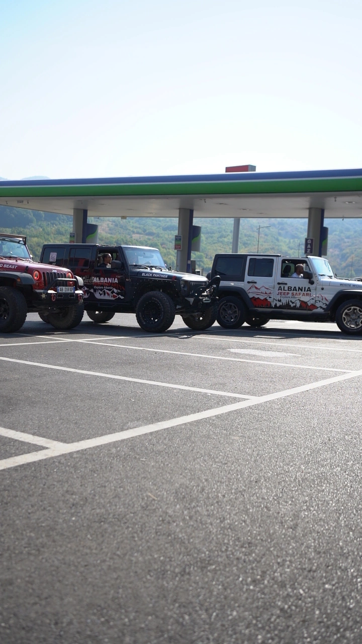 The red and white Wranglers parked side by side at the fuel stop