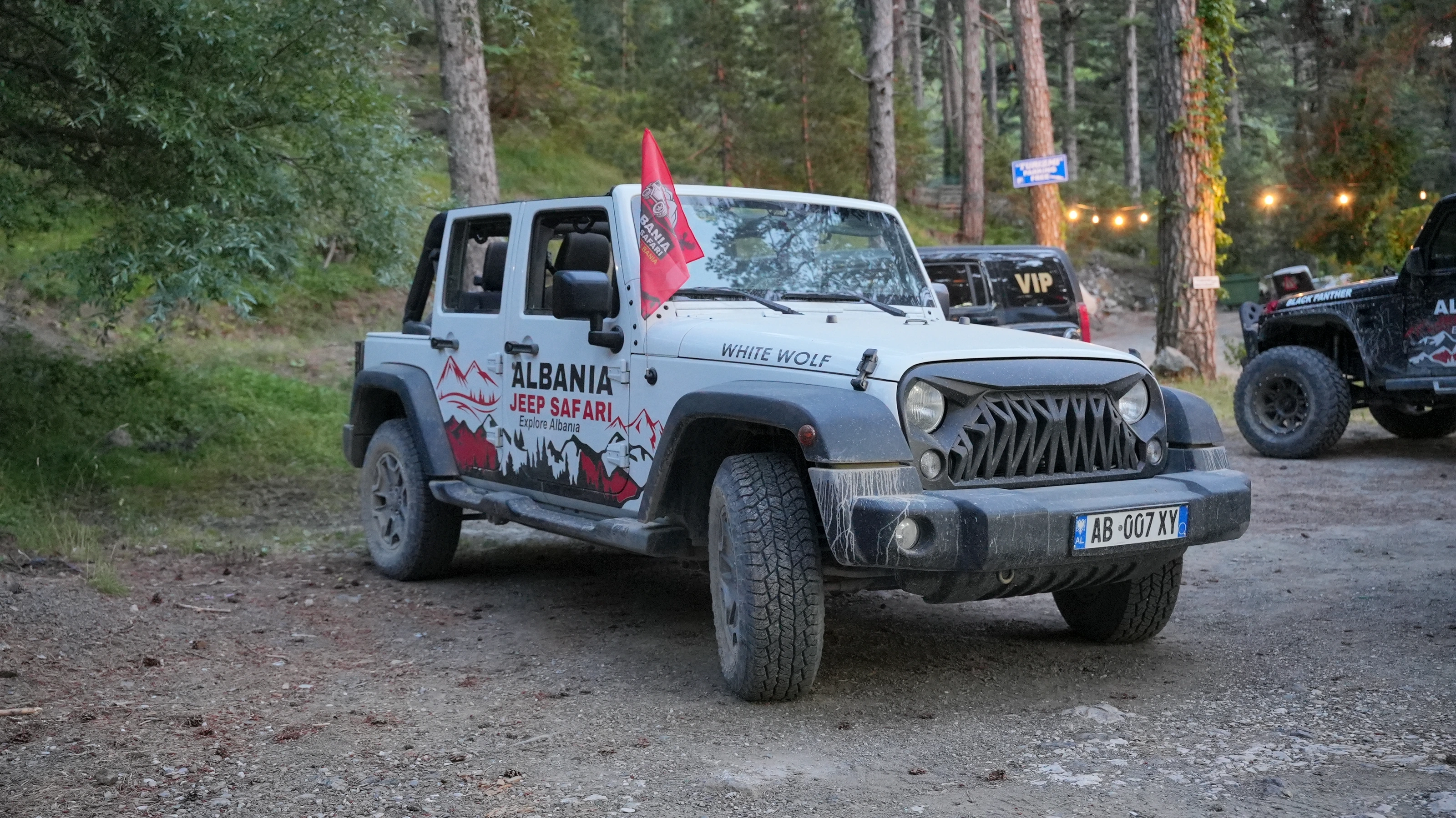 Silver Wrangler at the forest camp, red flag on the back